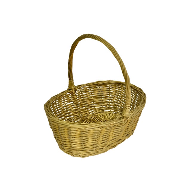 Large vintage hand woven 12 inch oval wicker basket with center handle with applied bronze gold tone highlights. Fill for...