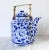 Vintage hexagon shape blue and white ceramic teapot with floral motif and brass handle. No makers mark. Minor wear. No chips.