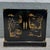 A striking vintage Chinoiserie sideboard featuring a glossy black lacquer finish adorned with hand-painted Asian landscape...