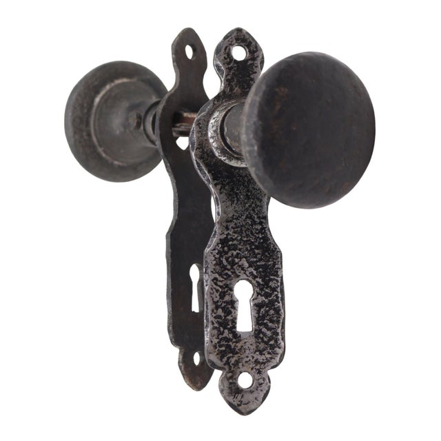 Arts & Crafts style door knob set made of cast iron with a black finish. Priced as two door knobs, two back plates, and a...
