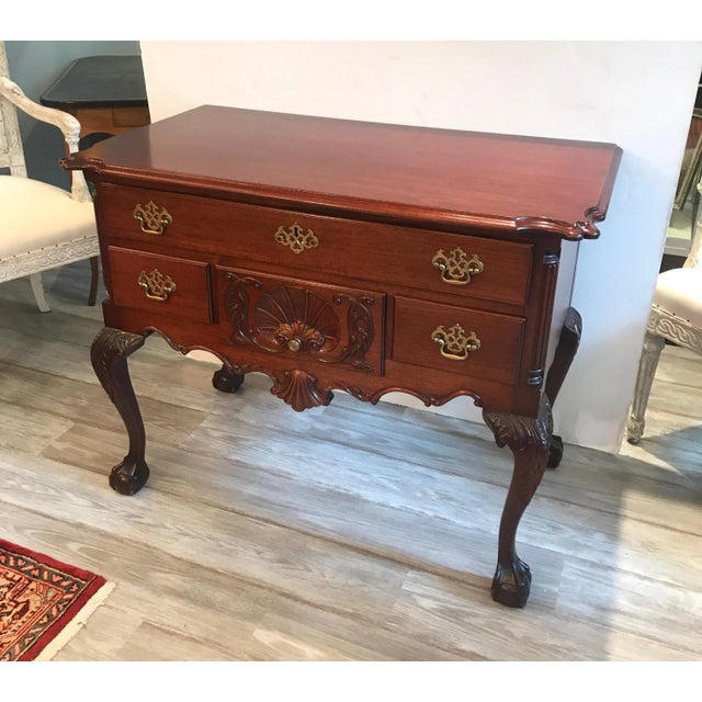 A classic Philadelphia Chippendale style hand carved mahogany lowboy. The upper long drawer with three smaller drawers...