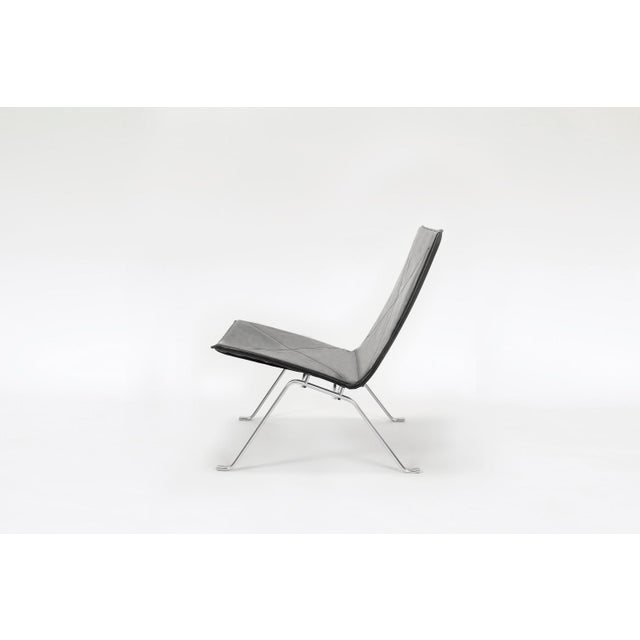 PK22 lounge chair designed by Poul Kjærholm and manufactured by Fritz Hansen. Featuring black leather seat and brushed...