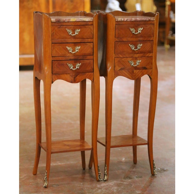Elegant and unusually petite, this matched pair of Louis XV-style bedside tables offers refined storage in a slender,...