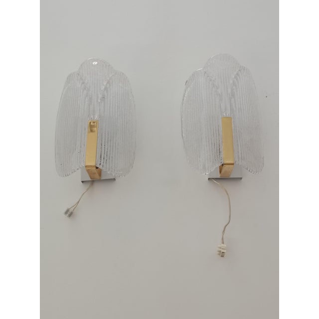Magnificent pair of wall sconces by carl fagerlund for orrefors. sweden, 1970s. brass structure supporting a sublime...