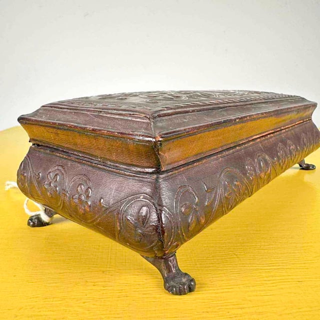 early 20th century wooden jewelery box covered in leather Height: 7 Width: 24 Depth: 10.5 This piece is attributed to the...