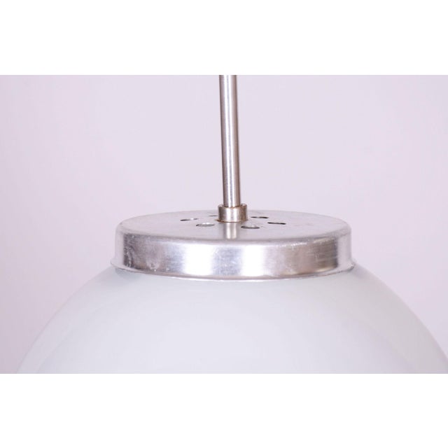 This chandelier is a classic representative of 1950s czechoslovak design, embodying the elegance of early mid-century...