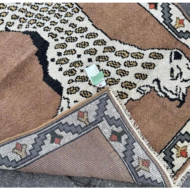 This vintage 1980s handmade rug showcases a dramatic large-scale cheetah motif, designed with confident proportions and...