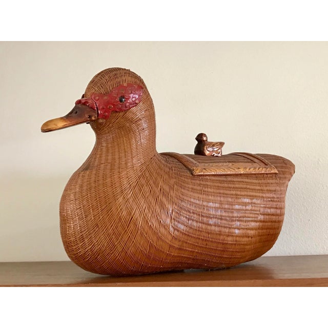 A wicker compartment basket in the form of a duck. From the Shanghai Collection of the 70s. Liddded with a duck finial....