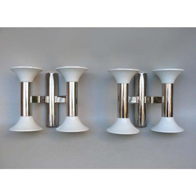 An absolutely rare and elegant pair of Space Age era 70's wall lights manufactured by Cosack. By using head-mirrored...