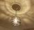 Mid Century Doria pendant light featuring a glass globe shade with irregular sculptural patches, aluminum cover and finial...