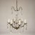 This is a petite French Louis XV style crystal and bronze six arm chandelier. It has been re-wired and newly cleaned. The...