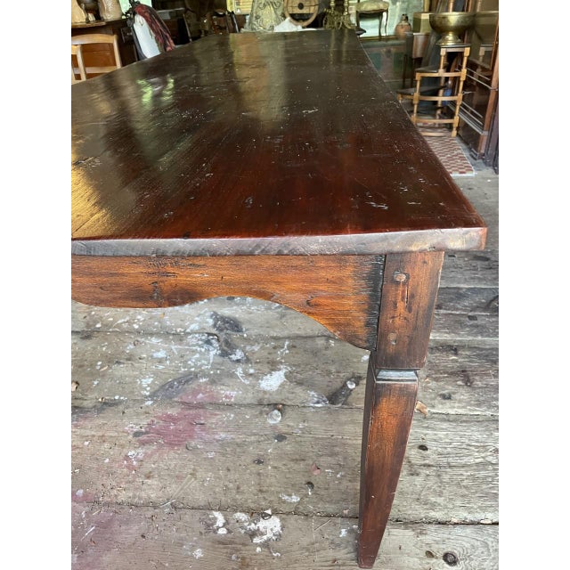 Lot #0133 Rustic, large and beautiful dining table of teakwood (“the Queen of woods”) with a three-board top, on tapered...