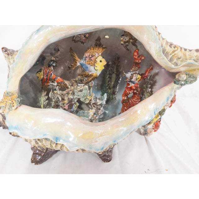 We are selling this interesting art pottery piece with shell shape and interior fish decoration, possibly Italian....