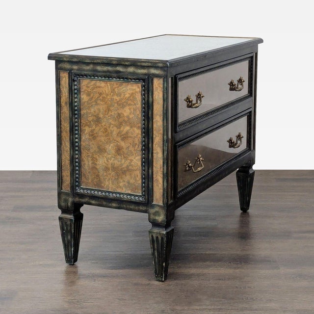 Theodore Alexander “Venetian Art Deco” two-drawer chest featuring handcrafted verre églomisé mirrored panels with an...