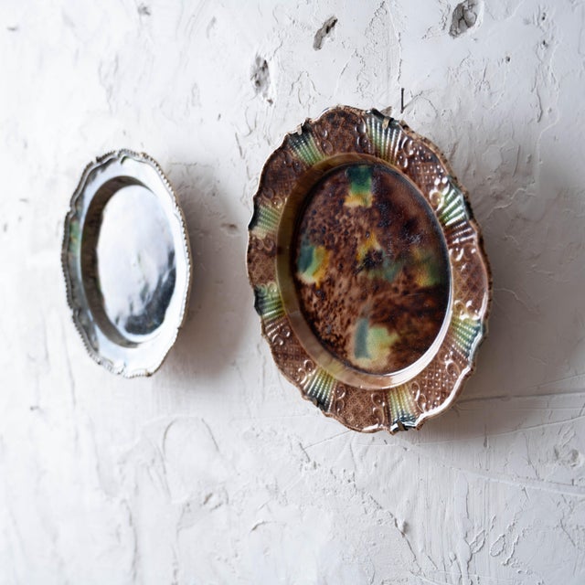 A pair of 18th-century English creamware plates in the tortoiseshell manner associated with Thomas Whieldon, circa 1760....