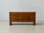 A striking mid-century sideboard crafted from oak, featuring clean, geometric lines. The straightforward construction,...