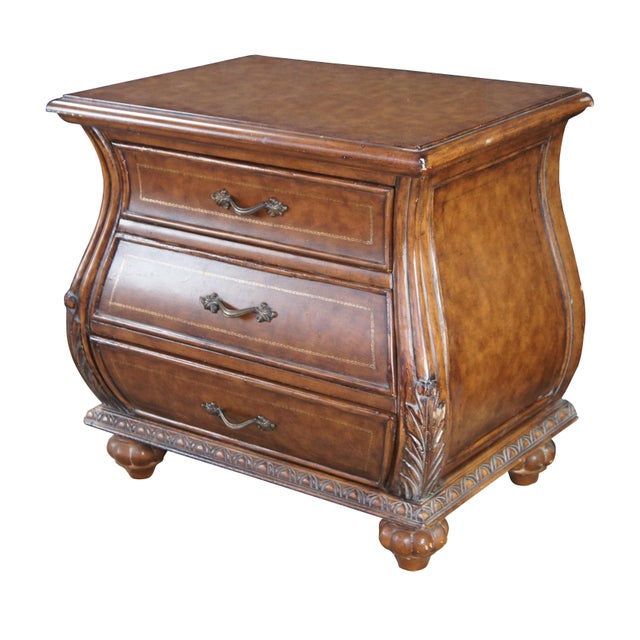 Vintage French Louis XVI style bombe dresser / chest of drawers / nightstands featuring a tooled leather design with...