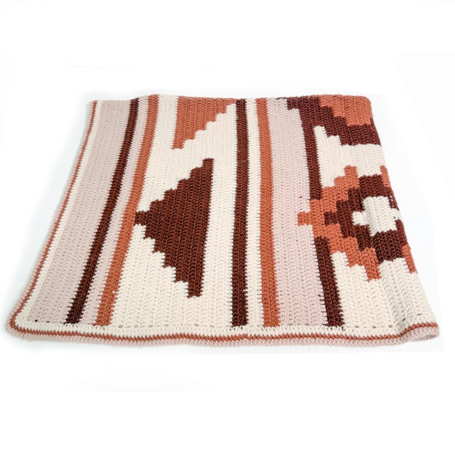 Beautiful vintage handmade crochet blanket with a wonderful mix of Southwestern-inspired geometric motifs and soft...
