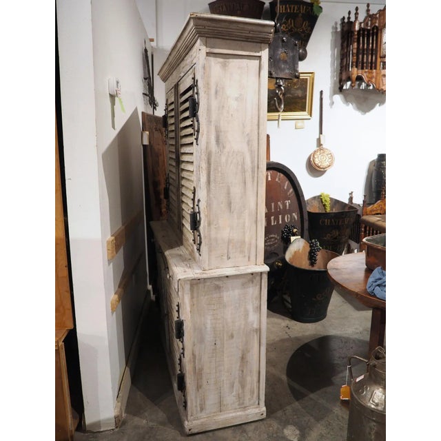 Assembled by a French artisan, this painted buffet has incorporated two pairs of antique shutter doors into the deux corps...