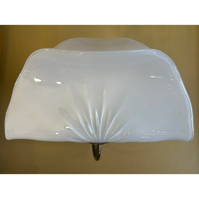 Pair of white opalescent blown glass sconces with organic leaf-like diffuser. Gilded metal frame. The free curve and...