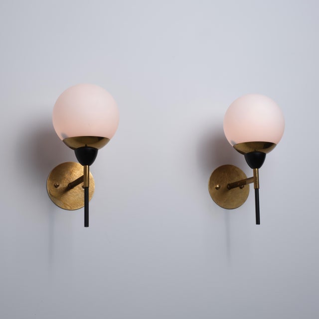 Pair of italian wall sconces dating from the 1950s, characterized by a refined geometric composition and a balanced...