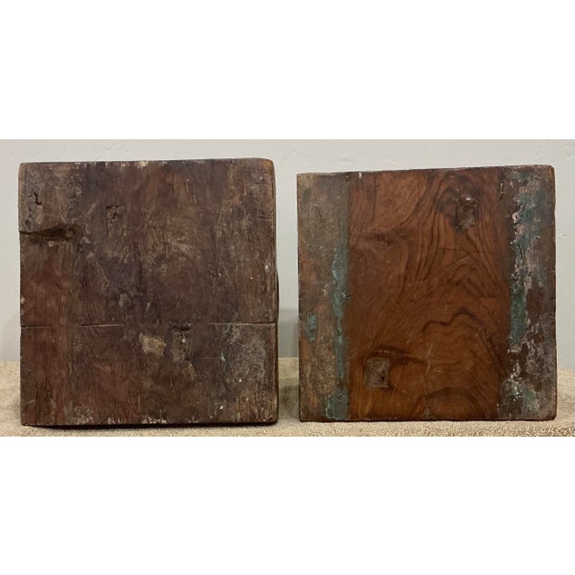 These reclaimed column bases are a heavy, dense hardwood. They have remains of previous paint jobs in turquoise and cream....