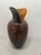 A striking studio blown art glass vase with dramatic sculptural presence. The body features a deep amber interior layered...