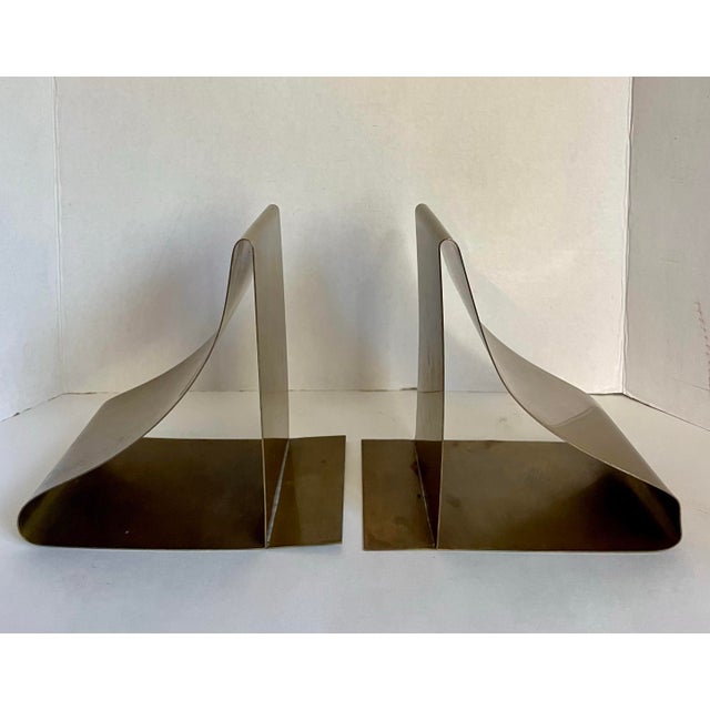 This striking pair of vintage mid-century modern brass bookends features a bold sculptural form created from smoothly...