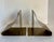 This striking pair of vintage mid-century modern brass bookends features a bold sculptural form created from smoothly...
