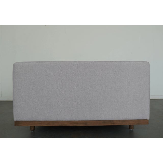 Refined yet relaxed, this modern chaise blends classic form with contemporary comfort. Set on a cocoa-finished parawood...