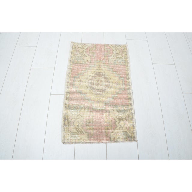 This is a vintage Turkish nomadic wool rug. The piece was handmade in the 1960s.