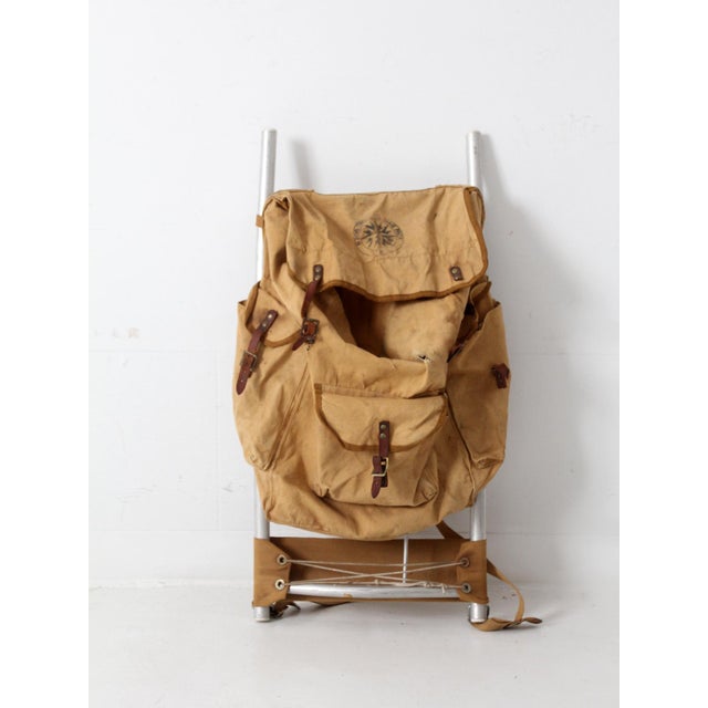 A mid-century American Two-Way Frame Pack, No. 206, featuring a lightweight aluminum frame paired with a canvas pack and...