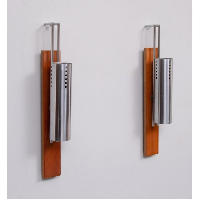 Beautiful set of Wall lamps. Polish stainless steel tube, mounted on a solid Nutwood base. Very nice quality lamps. 1970s...