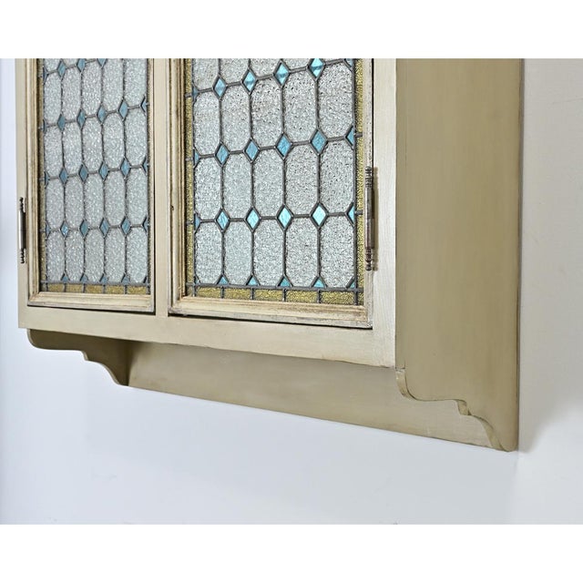 These dazzling French 19th century stained glass doors have been fitted into a custom wall-mounted cabinet for a unique...