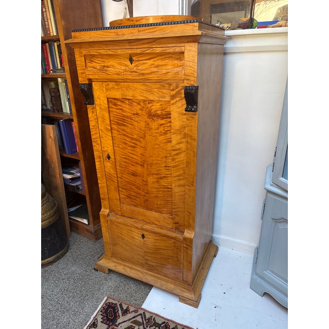 Antique Biedermeier Style Tall Cabinet. Flame and Burl Birch with Carved and Ebonized Column Caps and key holes. Concave...