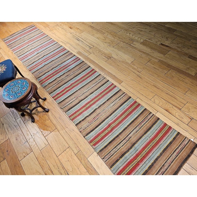 Vintage American Amish Rag Runner is in stripe design. The Amish Rag Runner has a stripes pattern in sage green, red,...