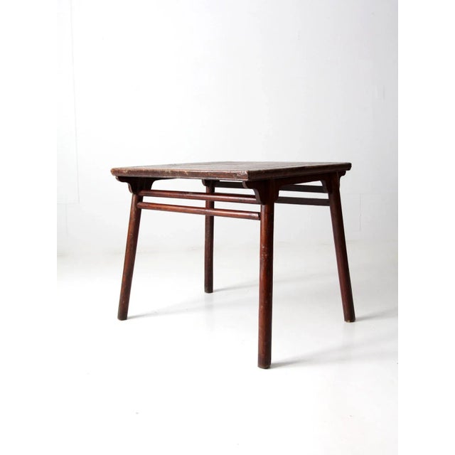 This beautiful 19th century Chinese table boasts a rich wooden finish with carved spandrels and double stretchers, adding...