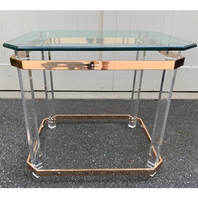 Modern clean lines define this side table. Clear lucite legs accented with brass and a thick octaginal beveled glass top....