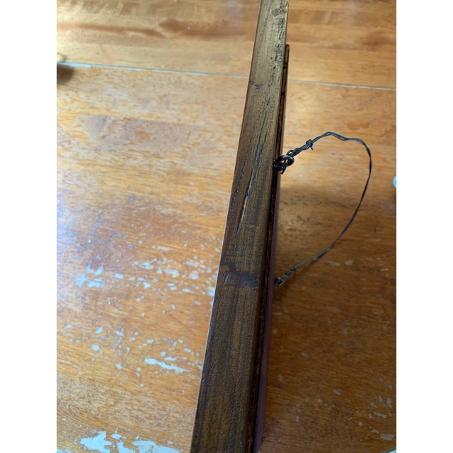 Antique wooden mirror with lovely carved details. The carved bow on the top extends the total height to 19 1/2 inches, the...