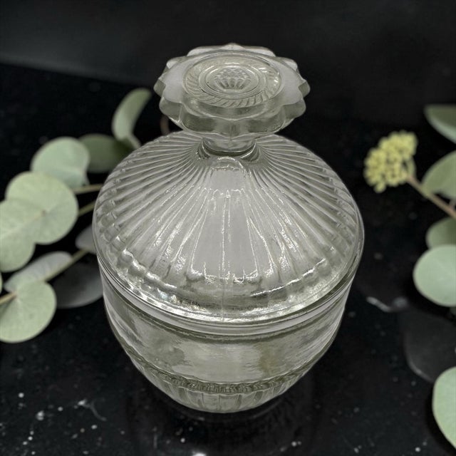 Vintage Clear Glass Vanity Jar With Matching Lid. Jar has a heavy ribbed texture on the bottom half of the base and across...