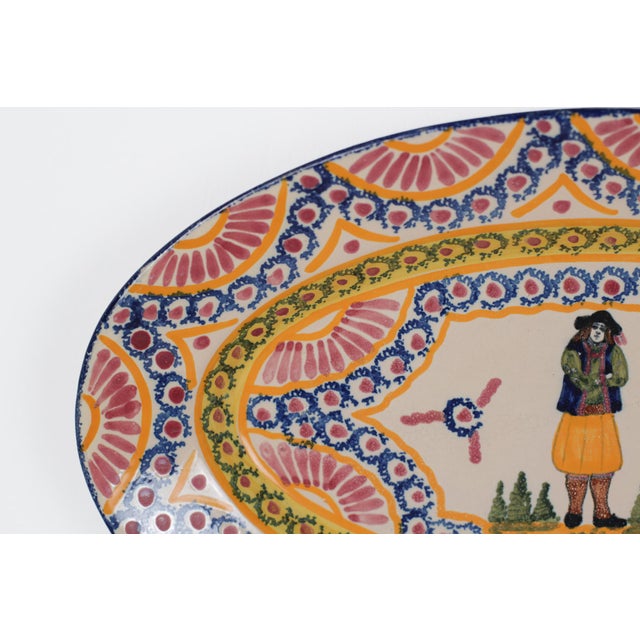 A mid-century vintage French Henriot Quimper faience oval platter featuring a hand-painted Breton man in traditional...