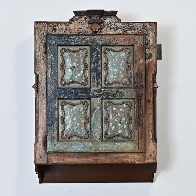 An extraordinary Portuguese door from the early 19th century, fitted onto a custom wall-mounted cabinet for a unique...