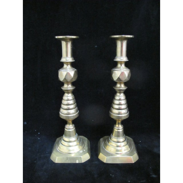 Pair of turn of the century English brass beehive candlestick holders with polished finish. 'Beehive' design characterized...