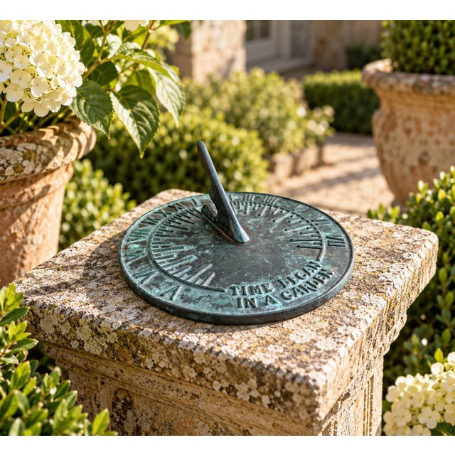 A classic vintage iron verdigris garden sundial inspired by traditional English estate landscapes, reading "Time Began in...
