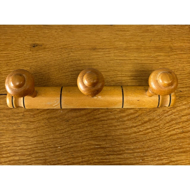 A charming vintage French wooden coat rack crafted in the classic faux bamboo style, a design long favored for its...