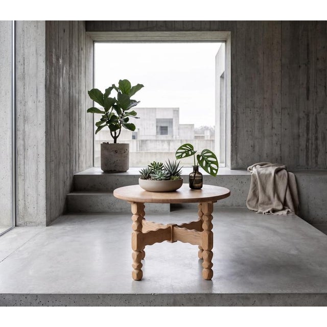 Round coffee table in solid oak attributed to Danish designer Henning Kjærnulf, produced in Denmark during the 1960s. The...