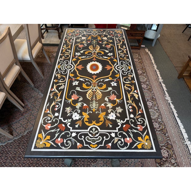 Design Plus Gallery presents a Pietra Dura Dining Table with Wrought Iron Base. The table top is the most stunning aspect...
