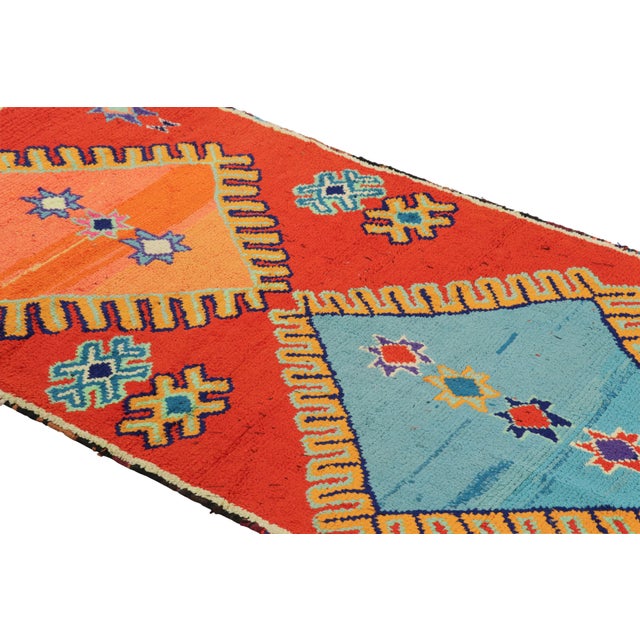 Hand-knotted in wool and originating from Morocco circa 1950-1960, this 3x7 vintage runner rug is a rare and among the...