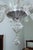 Venetian chandelier made of split glass with floral decorations in the shape of flowers and leaves. The chandelier is...