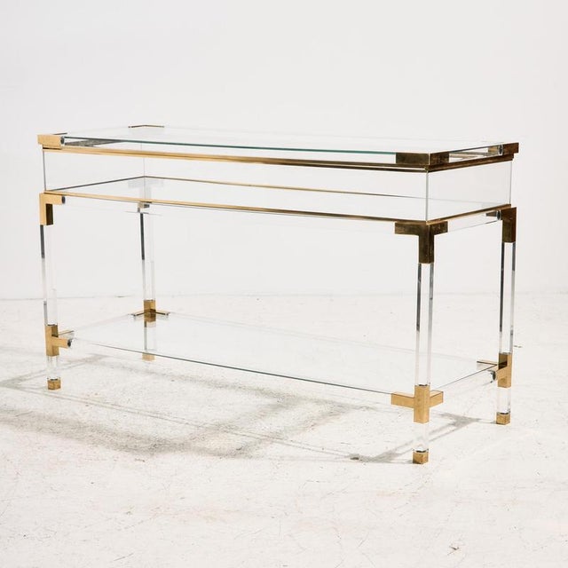 Italian Fabian console table from the 1970s with acrylic glass, glass and brass details. The table is multifunctional, as...